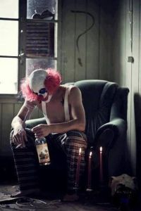 clown with drink and smoke